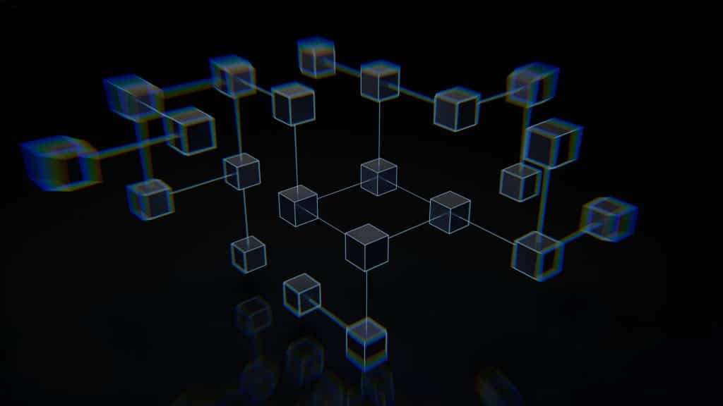 A group of interconnected cubes that are on a black surface.