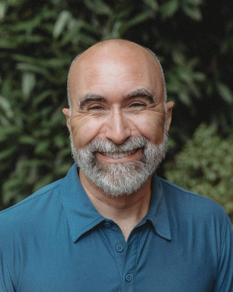 Chris Stinebaugh smiling and wearing a blue polo shirt.